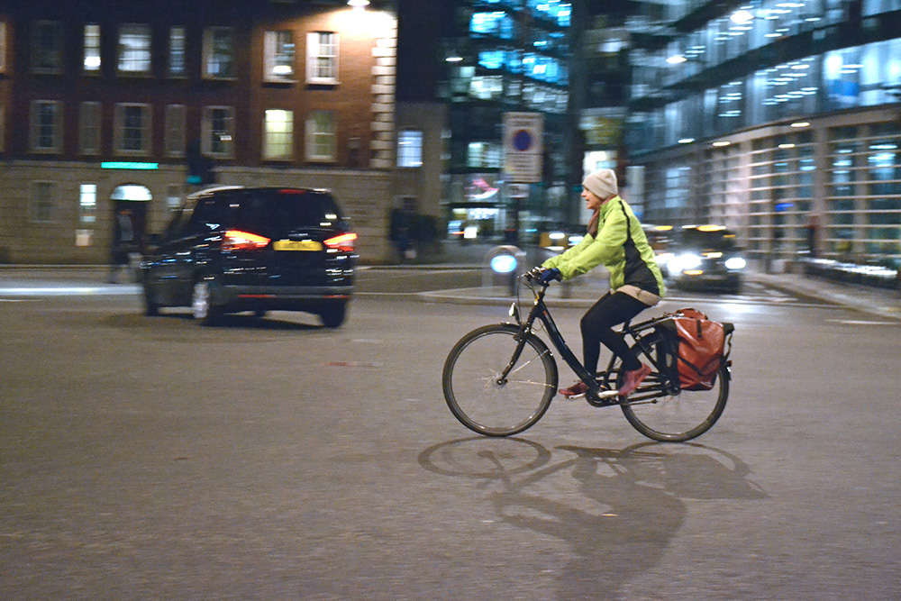 A woman cycling on bike in London street. Photo: Barbora Zelenkova, London, 2016.